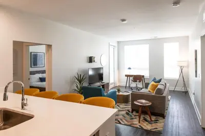 a living room with a couch and a table at CozySuites at ArtCincy in Cincinnati