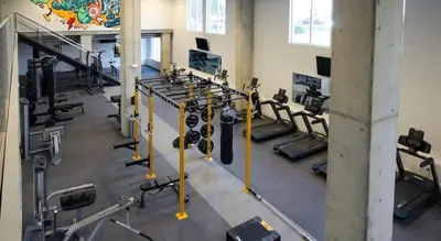 a gym with several rows of tread machines at CozySuites at ArtCincy in Cincinnati