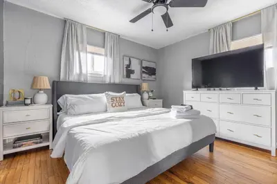 a bedroom with a large bed with a ceiling fan at Westlake Escape in Westlake
