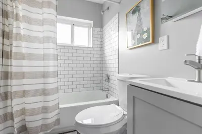 a white bathroom with a toilet and a sink at Westlake Escape in Westlake
