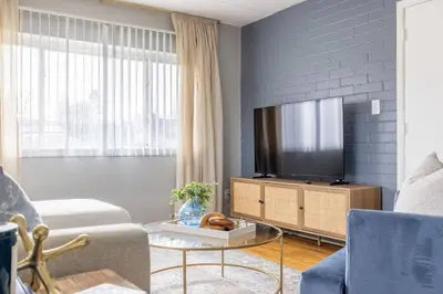 a living room with a flat screen tv on a cabinet at Westlake Escape in Westlake