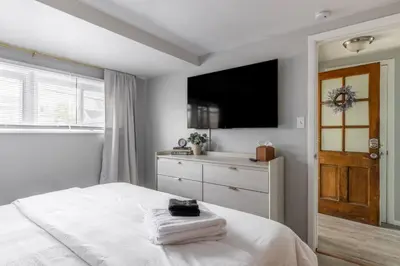 a bedroom with a bed with a television and a dresser at Quiet Modern Home w/ Hot Tub! in Parma
