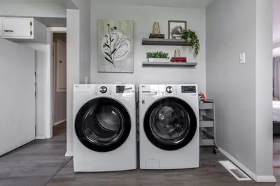 a laundry room with two washing machines in it at Quiet Modern Home w/ Hot Tub! in Parma