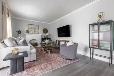 a living room with a couch and a table at Quiet Modern Home w/ Hot Tub! in Parma