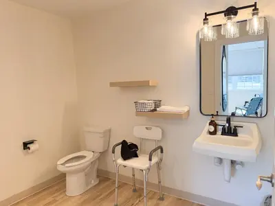 a bathroom with a toilet and a sink and a mirror at Explorer Rest & Recreation in Sandusky
