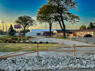 a fence and rocks in front of a building at Explorer Rest & Recreation in Sandusky