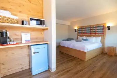 a hotel room with a bed and a refrigerator at Explorer Rest & Recreation in Sandusky