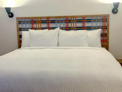 a bedroom with a white bed with white pillows at Explorer Rest & Recreation in Sandusky