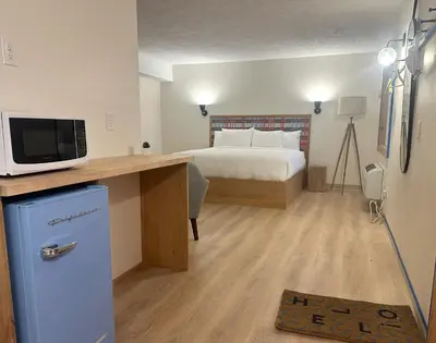 a bedroom with a bed and a desk with a tv at Explorer Rest & Recreation in Sandusky