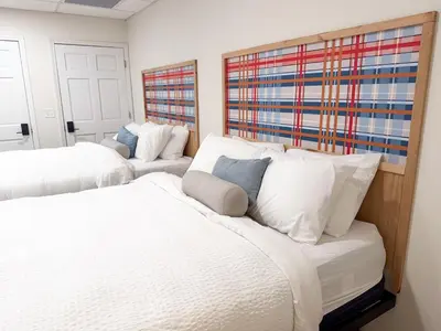 two beds in a bedroom with white pillows at Explorer Rest & Recreation in Sandusky