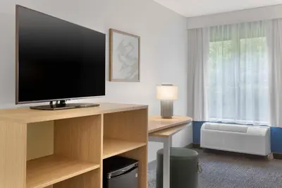 a hotel room with a television on a desk at Spark By Hilton Newcomerstown in Newcomerstown
