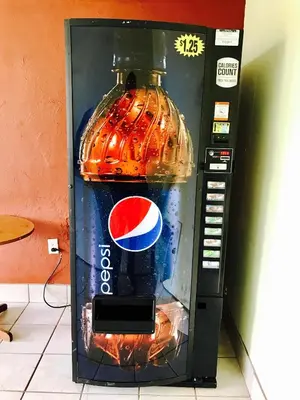 a soda machine with a pepsi bottle in it at Greystone Motel in Hillsboro