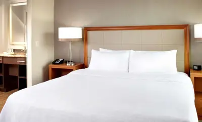 a large white bed in a hotel room at Homewood Suites by Hilton Pittsburgh Airport/Robinson Mall Area in Moon Township