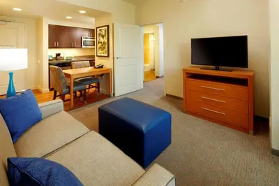 a living room with a couch and a flat screen tv at Homewood Suites by Hilton Pittsburgh Airport/Robinson Mall Area in Moon Township