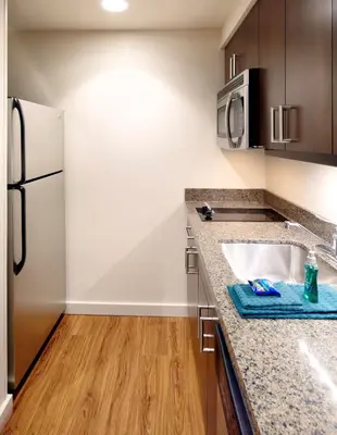 a kitchen with a sink and a refrigerator at Homewood Suites by Hilton Pittsburgh Airport/Robinson Mall Area in Moon Township