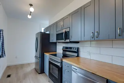 a kitchen with stainless steel appliances and wooden counter tops at Modern Family Home in Mason with Backyard and Fire Pit in Mason