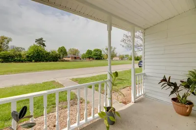 a porch with a white railing and a view of a street at Modern Family Home in Mason with Backyard and Fire Pit in Mason