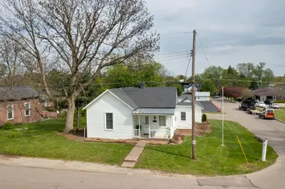 a small white house on the corner of a street at Modern Family Home in Mason with Backyard and Fire Pit in Mason