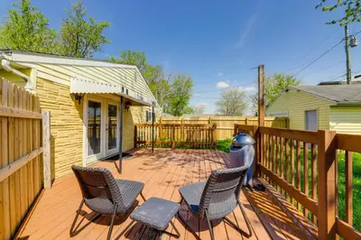 a wooden deck with chairs and a fence at Pet-Friendly Ohio Escape with Deck and Community Dock! in Celina