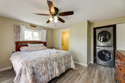 a bedroom with a bed and a washing machine at Pet-Friendly Ohio Escape with Deck and Community Dock! in Celina