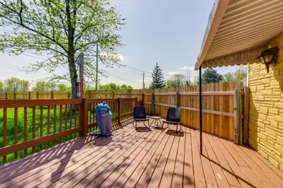 a deck with two chairs and a trash can at Pet-Friendly Ohio Escape with Deck and Community Dock! in Celina