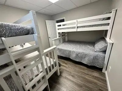 a room with two bunk beds and a cat in it at Suite 1 in Butler