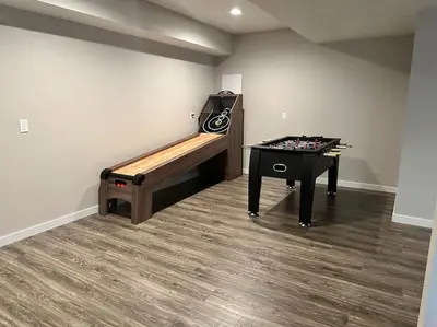 a room with a ping pong table and a bench at Suite 1 in Butler