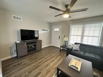 a living room with a couch and a flat screen tv at Suite 1 in Butler