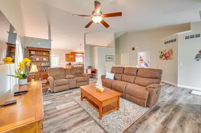 a living room with a couch and a table at Home with Private Pool - 15 miles to Ark Encounter! in Berry
