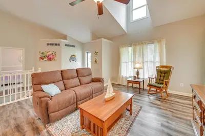 a living room with a couch and a table at Home with Private Pool - 15 miles to Ark Encounter! in Berry