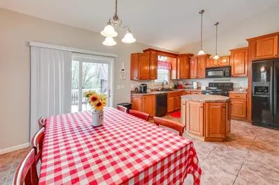 a kitchen with a table with a red and white checkered table cloth at Home with Private Pool - 15 miles to Ark Encounter! in Berry