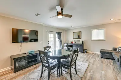 a dining room and living room with a table and chairs at Home with Private Pool - 15 miles to Ark Encounter! in Berry