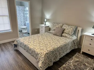 a bedroom with a bed and a bathroom at Suite 2 in Butler