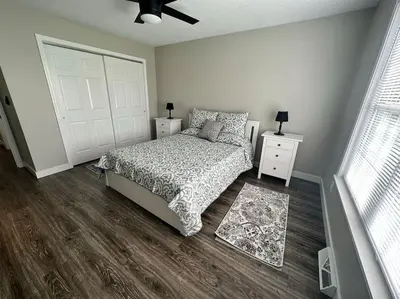 a bedroom with a bed and a white door at Suite 2 in Butler