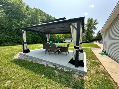 a patio with a table and chairs under a canopy at Suite 2 in Butler