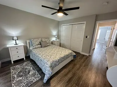 a bedroom with a bed and a ceiling fan at Suite 2 in Butler