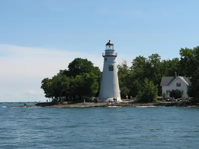 a lighthouse on an island in the water at South Beach Resort Hotel in Marblehead