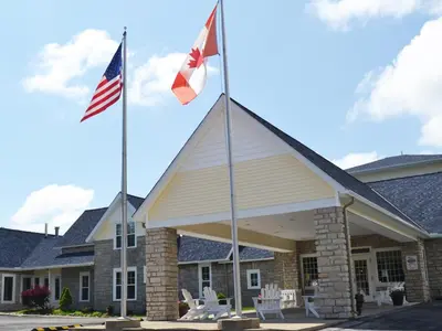 two flags flying in front of a building at South Beach Resort Hotel in Marblehead