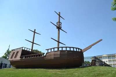 a large boat sitting on top of a grass field at South Beach Resort Hotel in Marblehead