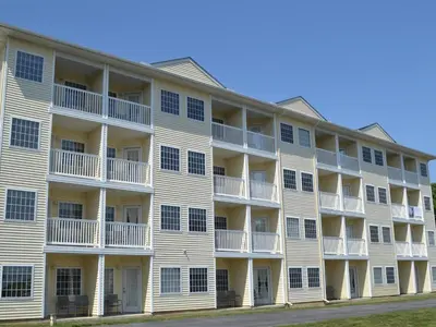 a large white apartment building with balconies at South Beach Resort Hotel in Marblehead