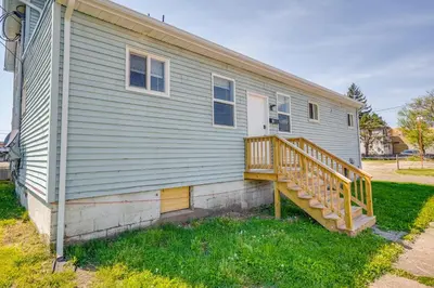 a house with a wooden staircase on the side of it at Zanesville Vacation Rental Near Downtown in Zanesville