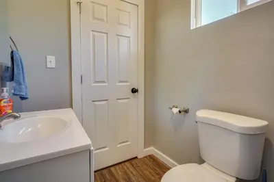 a bathroom with a white toilet and a sink at Zanesville Vacation Rental Near Downtown in Zanesville