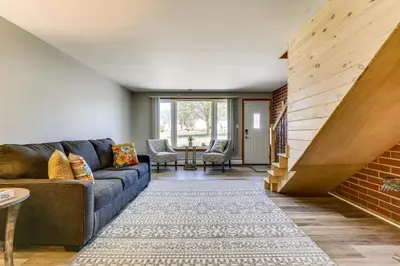 a living room with a couch and a brick wall at Indian Lake Vacation Rental with Fire Pit and Sauna in Lakeview