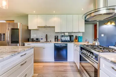 a kitchen with white cabinets and a blue refrigerator at Indian Lake Vacation Rental with Fire Pit and Sauna in Lakeview