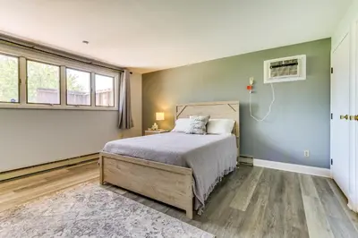 a bedroom with a bed and a fan and windows at Indian Lake Vacation Rental with Fire Pit and Sauna in Lakeview