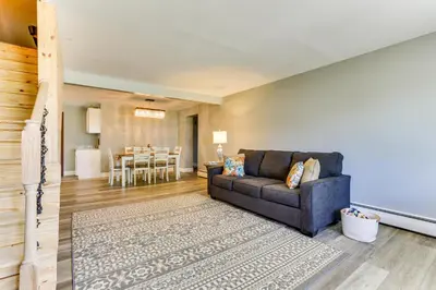 a living room with a couch and a dining room at Indian Lake Vacation Rental with Fire Pit and Sauna in Lakeview