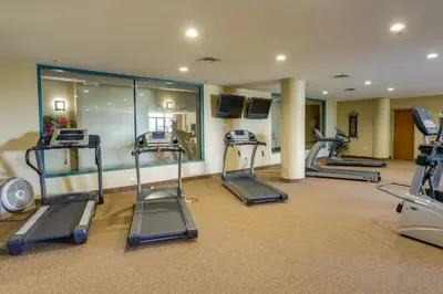 a gym with treadmills and ellipticals in a room at Waterfront Sandusky Vacation Rental Downtown! in Sandusky