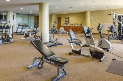 a gym with several exercise bikes and treadmills at Waterfront Sandusky Vacation Rental Downtown! in Sandusky