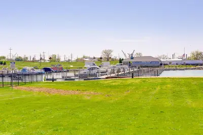 a marina with boats in a grassy field at Waterfront Sandusky Vacation Rental Downtown! in Sandusky
