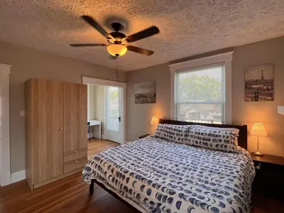 a bedroom with a bed and a ceiling fan at Rolston 2, Two Bedroom near Xavier Downtown in Bellevue